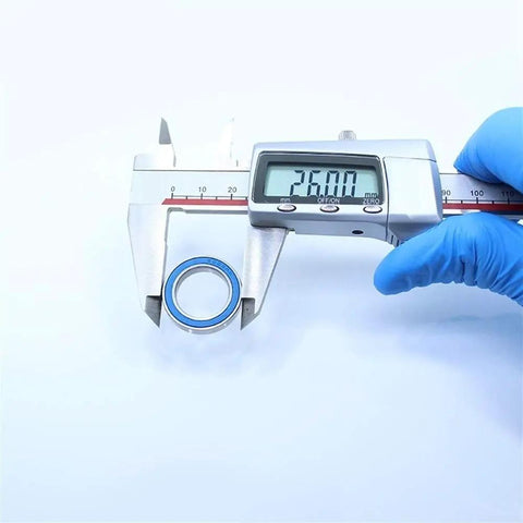Digital caliper measuring 26mm diameter of 6803RS Deep Groove Ball Bearing in blue, part of a set for RC cars, 17x26x5 mm size.