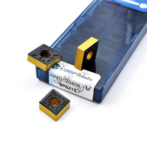 CNMG120408-TM carbide turning inserts in blue storage case; two yellow-coated inserts visible.