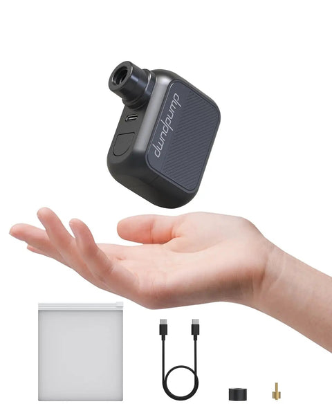 Pocket Sized Electric Bike Pump With 100 PSI in hand showing lightweight, USB-C cable and accessories visible.