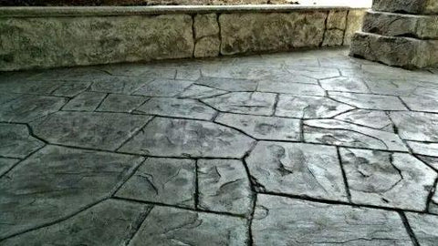 The Real Deal Low Solids Penetrating Concrete Curing And Sealing Agent Boosted With Silicone Resin Benefits For Worry Free Maintenance Of Decorative Slabs 5 Gallon Drum applied on textured outdoor concrete surface.