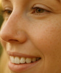 14K Gold Filled L Shaped Nose Stud With Tiny 1mm Micro Ball, 24G Thin Post 0.5mm, Hypoallergenic Minimalist Nostril Piercing Jewelry For Women, close-up on nose
