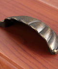 One Piece Zinc Alloy Kitchen Drawer Cabinet Door Handle Knob With Antique Bronze And Black Finish on wooden surface