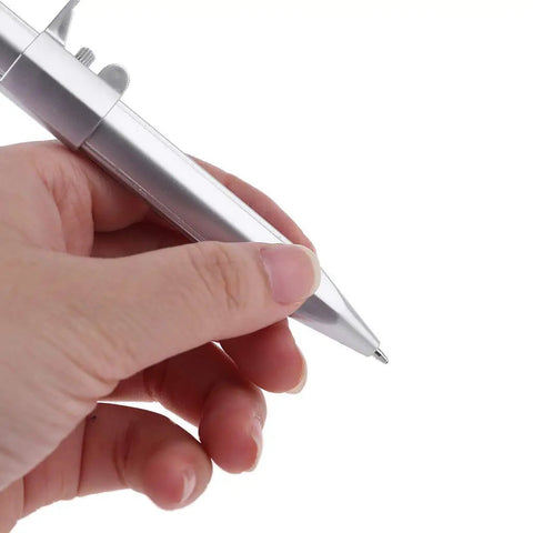 Person holding an Accuracy Calipers Pen with Double Scale for Easy Measurement, showcasing its ergonomic design and silver finish.