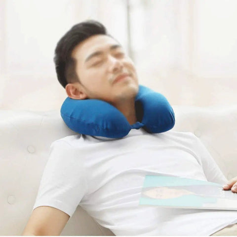 Man relaxing with Memory Foam Travel Neck Pillow For Airplanes And Cars Breathable Compact Flight Kit For Restful Sleep Supportive