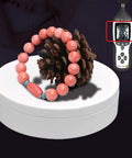 Luxury Electric Rotating Jewelry Display Stand With Mirrored Base, Smooth Spin Turntable For Rings, Necklaces & Watches on white box with coral bracelet.