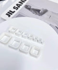 Rectangle Silicone Ear Tunnels And Plugs 00G 10MM Hollow Square Flexible Gauges Set on white surface