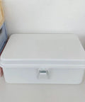 Heavy Duty Vintage White Metal Toolbox Featuring A Tight Snap Shut Locking Latch Tin Storage Case For Everyday Gear And Art Supplies Classic Secure Organizer Trunk on a table.