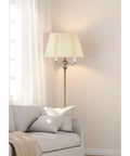 Antique Brass Floor Lamp With Six Way Torchiere, 150 Watt Power, 59 Inch Tall Iron Hammered Base next to sofa in living room.