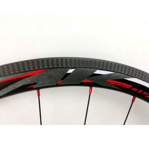 Close-up of carbon fiber rim with red and black details, part of 700C Road Carbon Fiber Fat Ring Disc Brake Wheel Set.