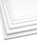 Close-up of white HDPE plastic sheet, 6 x 6 in, 1/4 in thick, showing beveled edges.