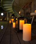 Outdoor Waterproof Flameless LED Pillar Candles Set 6 8 10 Inch with Remote and Timer by a poolside patio at night