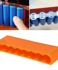 Top Grade 2PC Adjustable Battery Pack Spot Welding Clamps Made From High Heat Resistant Industrial Plastic, Stop Rolling For Easy Install And Solid Grip In Any Project - orange anti-roll clamps with cylindrical cells.