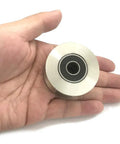 Badass Durability 304 Stainless Steel Pulley Roller Wheel with Silent Double Bearings in hand, showing size and design for gate installation.