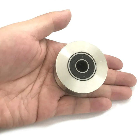 Badass Durability 304 Stainless Steel Pulley Roller Wheel with Silent Double Bearings in hand, showing size and design for gate installation.