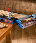 Speed Cope Crown Molding Jig With Adjustable Handle for DIY woodworking on a table, holding crown molding for cutting.