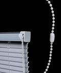 Close-up of white plastic bead chain connected to window blinds, part of Bead Chain Repair Kit For Window Blinds And Shades, 10 Meter White Plastic Bead Chain With 10 Connectors, Compatible With Roller Roman Vertical Blinds And Curtains, Durable And Easy To Use, Efficient Bead Chain Repair.