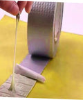 Heavy Duty Butyl Aluminum Foil Tape Sealant 2 Rolls That Work Like A Champ For Emergency Roof Leak Repair And Window Crack Fix Outdoor Pipe Leak Stop Tape Waterproof Sealing Tape For Glass Metal Wood Plastic Tiles And More being unrolled on surface