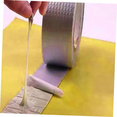 Heavy Duty Butyl Aluminum Foil Tape Sealant 2 Rolls That Work Like A Champ For Emergency Roof Leak Repair And Window Crack Fix Outdoor Pipe Leak Stop Tape Waterproof Sealing Tape For Glass Metal Wood Plastic Tiles And More being unrolled on surface