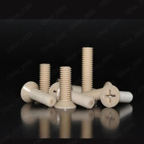Top Shelf PEEK Plastic Phillips Countersunk Flat Head Screws M1.2 Through M8 Heavy Duty polymer fasteners displayed on a reflective surface.