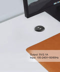 Recessed USB Power Grommet For Sleek Desk And Sofa Setup Featuring Built In Dual Fast Charging Ports With Totally Hidden Cord Routing For A Clean Game Vibe on a white desk next to a brown leather pad.