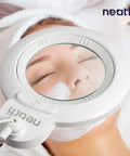 XL Bifocals 1200 Lumens LED Magnifying Lamp With Clamp, 3 Light Modes, showing hands-free use during skincare treatment