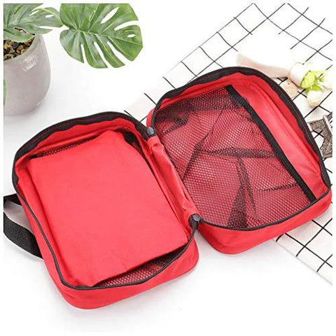 Red PAXLAMB first aid bag, open view showing mesh-pocket section and empty inner compartments