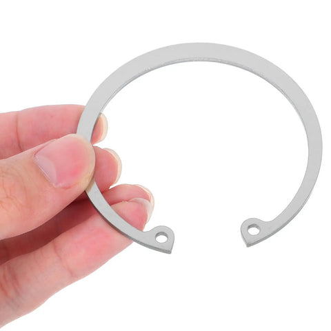 Hand holding a piece from Stainless Steel C Shaped Retaining Rings Set With Elastic Design, 5 Pieces, Internal Snap Ring Kit For Holes And Pins.
