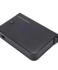 Mini UPS Backup Power Supply For Routers Modems And Security Cameras With 36W US Plug Portable Battery, top view, black casing.