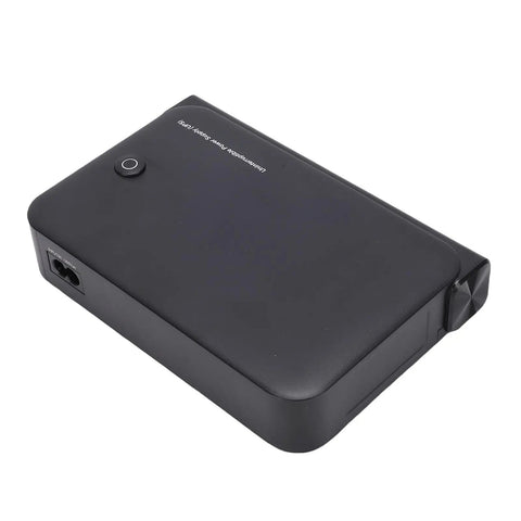 Mini UPS Backup Power Supply For Routers Modems And Security Cameras With 36W US Plug Portable Battery, top view, black casing.