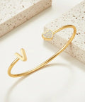 Gold bangle with V initial and zircon heart from Personalized Dope Initial Letter Bangle For Women Gold Stainless Steel Heart Cuff.