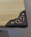 Solid As A Rock Metal Corner Protectors For Furniture Featuring Dope Vintage Floral Accents Seriously Rust Resistant Heavy Duty Edge Guards on a table corner.