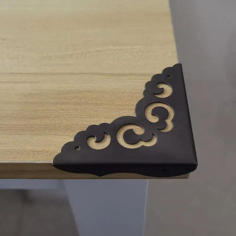 Solid As A Rock Metal Corner Protectors For Furniture Featuring Dope Vintage Floral Accents Seriously Rust Resistant Heavy Duty Edge Guards on a table corner.