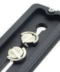 Close-up of 150mm universal quick release plate with 1/4 and 3/8 inch mounting screws, Arca-Swiss compatible lightweight aluminum.