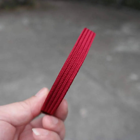 Hand holding red Silk Ito Sageo Wrapping Cord Sixteen Point Four Ft For Katana Wakizashi Samurai Swords Pro Grade Durable Synthetic Silk Ito Cord