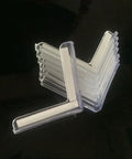 Top Shelf Clear PVC Corner Guards 8 Pack L Shaped Protective Bumpers For Tables And Doors Transparent stacked on a black surface.