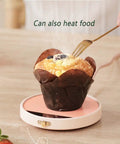 Smart Electric Coffee Mug Warmer Triple Temperature Settings Digital Display keeps muffin warm on pink compact base.