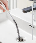 Flexible Drain Snake Cleaner Brush That Kicks Out Greasy Gunk Reusable Spiral Hair Removal Tool With Comfort Grip Handles For Sinks Showers And Bathtubs In White removing hair from sink drain.
