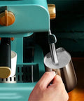 Electric Coffee Maker With Auto Milk Frother For Smooth Cappuccino Sips in use with steaming milk pitcher.