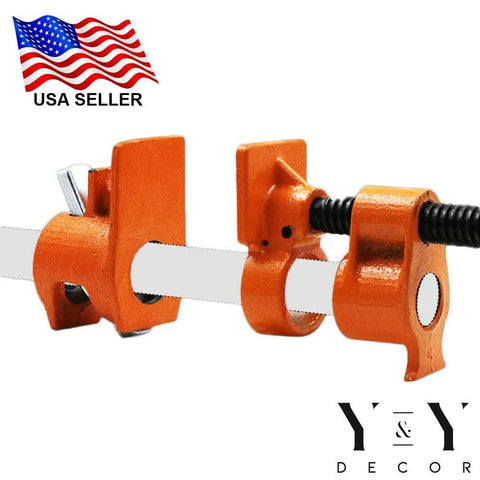Close-up of half inch pipe clamps showing beefy cast iron body and high torque lead screw for woodworking clamping power.