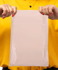 Waterproof PE Packaging Bags With Easy Seal 100 Pack Large Khaki Mailing Envelopes shown held up with easy-seal closure visible.