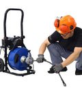 Heavy Duty Electric Sewer Snake Auger With 60 Foot Cable and 4 Cutter Heads features a 250 Watt motor and steel drum in use.