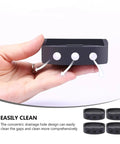 Hand holding a black rubber mat, part of 4 Pack Black Rubber Anti Skid Shock Absorbing Mats For Washing Machines And Furniture Feet Pads