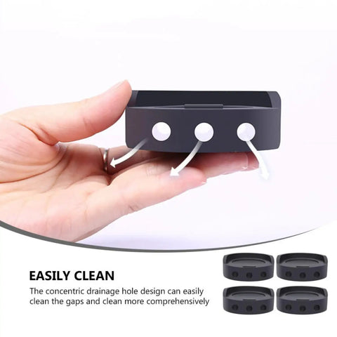 Hand holding a black rubber mat, part of 4 Pack Black Rubber Anti Skid Shock Absorbing Mats For Washing Machines And Furniture Feet Pads