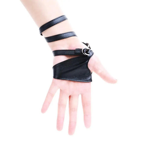 Dope Women Fingerless Gloves Crafted From Supple Faux Pu Leather For Nightouts And Punk Scenes Ultra Flexible Half Palm Wrist Cuff In Classic Matte Black Finish on a hand with straps.