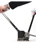 GD35 Manual Sealless Steel Strapping Machine Innovative Combination Banding Tool in use with gloves tightening steel strap.