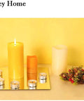 Candles and decor on one of twelve 12 inch frameless mirror tiles for home gym and garage create custom full length wall reflections.