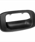 Tailgate handle bezel cover in black textured plastic for Silverado/Sierra 1999–2007 rear exterior (close-up)