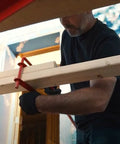 Metaltech Pump Jack Brace 2201; red clamp on a wooden beam during setup