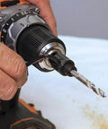 Klein Tools 31905 hole saw arbor with adapter, 3/8-inch, mounted on an orange cordless drill