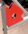 Check Out This Crazy Cool 6Pc Magnetic Welding Fixture Tool For Super Stable Support And Precision Positioning On All Your Soldering Jobs Without Deformation Woes. Red magnetic holder positioned on frame.